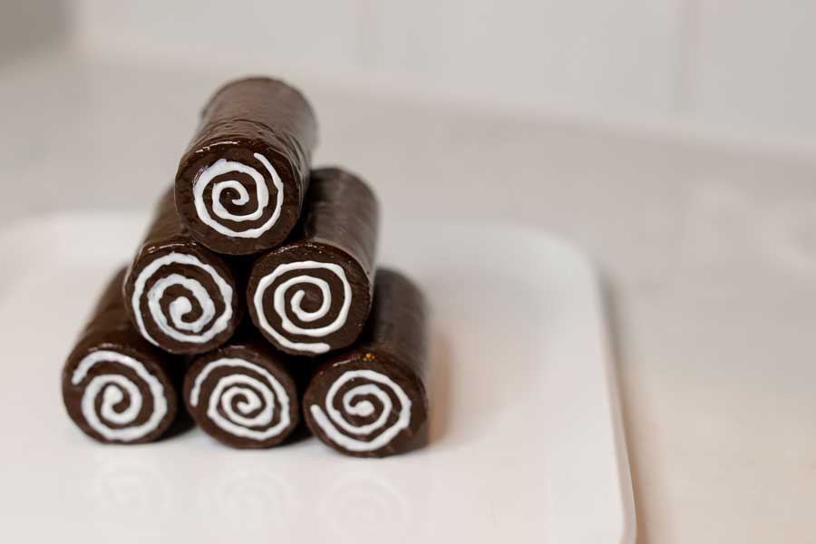 a pyramid stack orf faux swill rolls they are brown with a white swirl in the middle